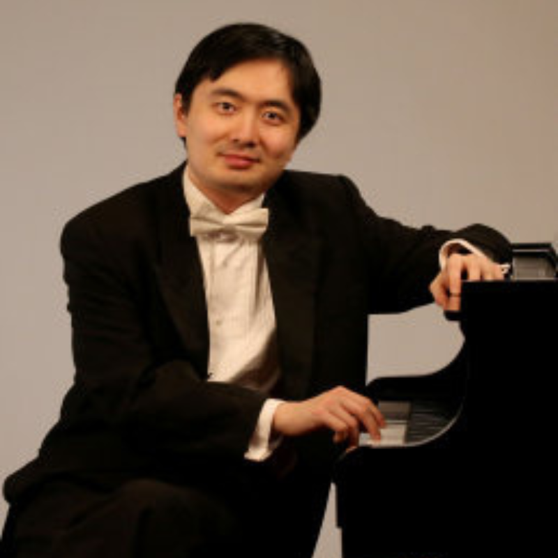 Pianist Sheng Cai seated at piano